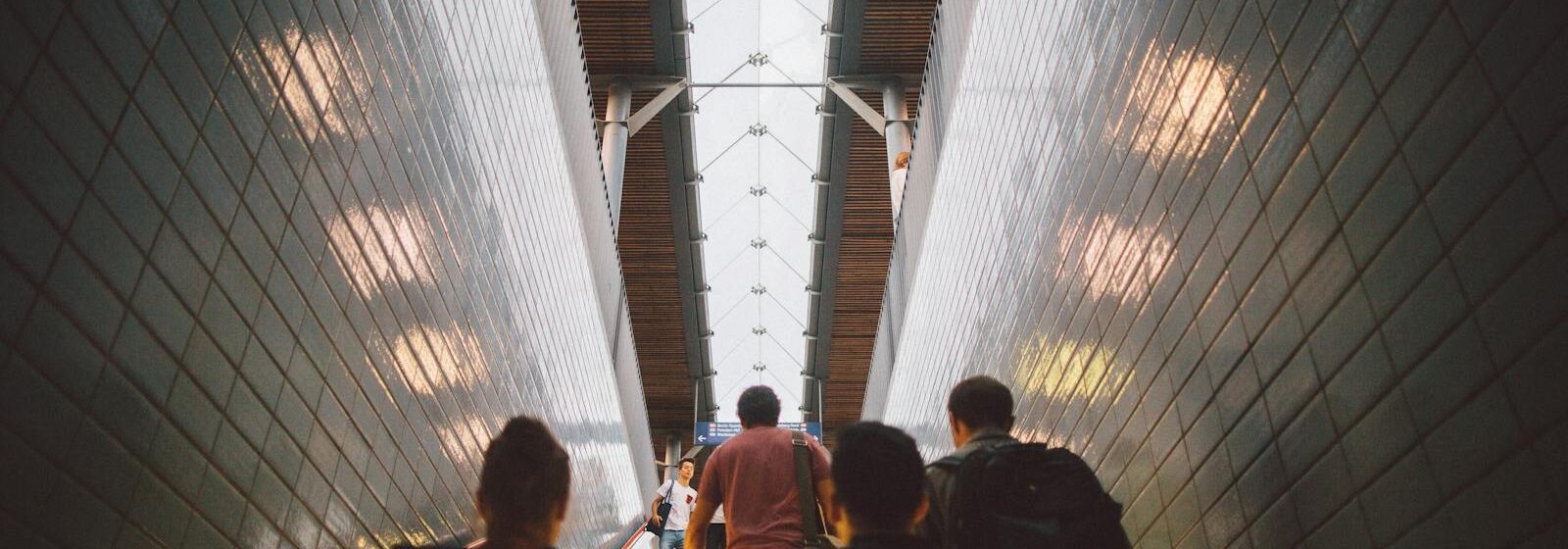 Group of diverse commuters walking up a tiled stairway in Berlin station. Management, cadres, dirigeants