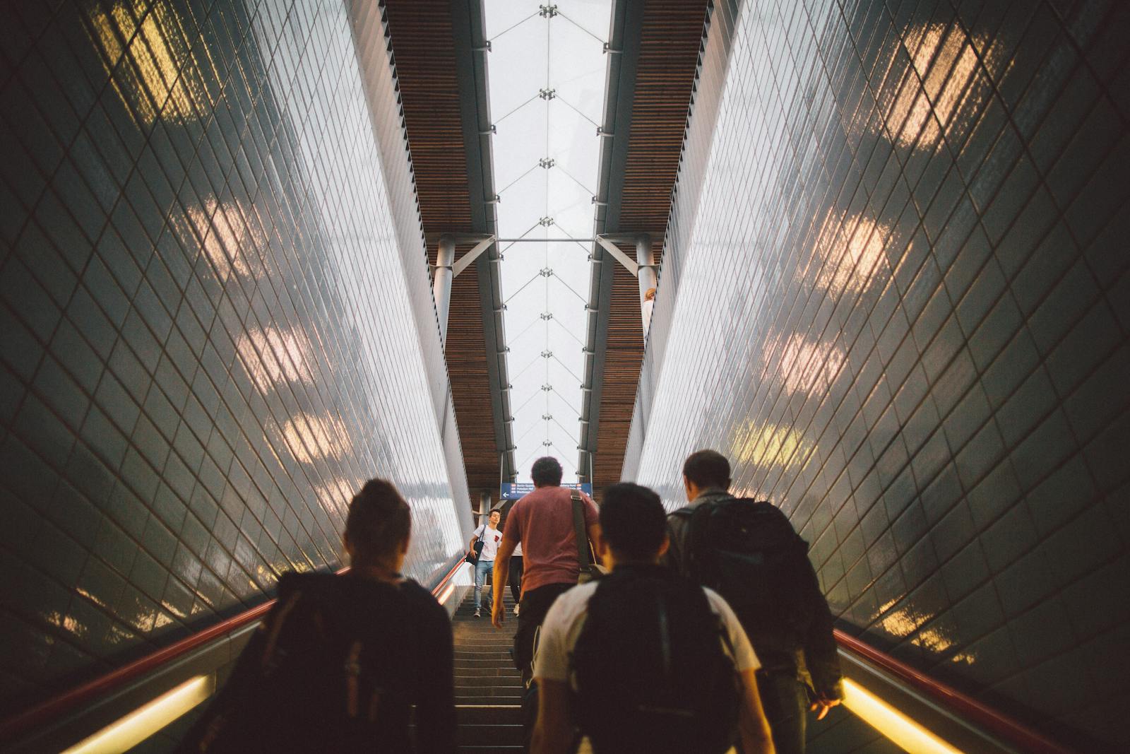 Group of diverse commuters walking up a tiled stairway in Berlin station. Management, cadres, dirigeants