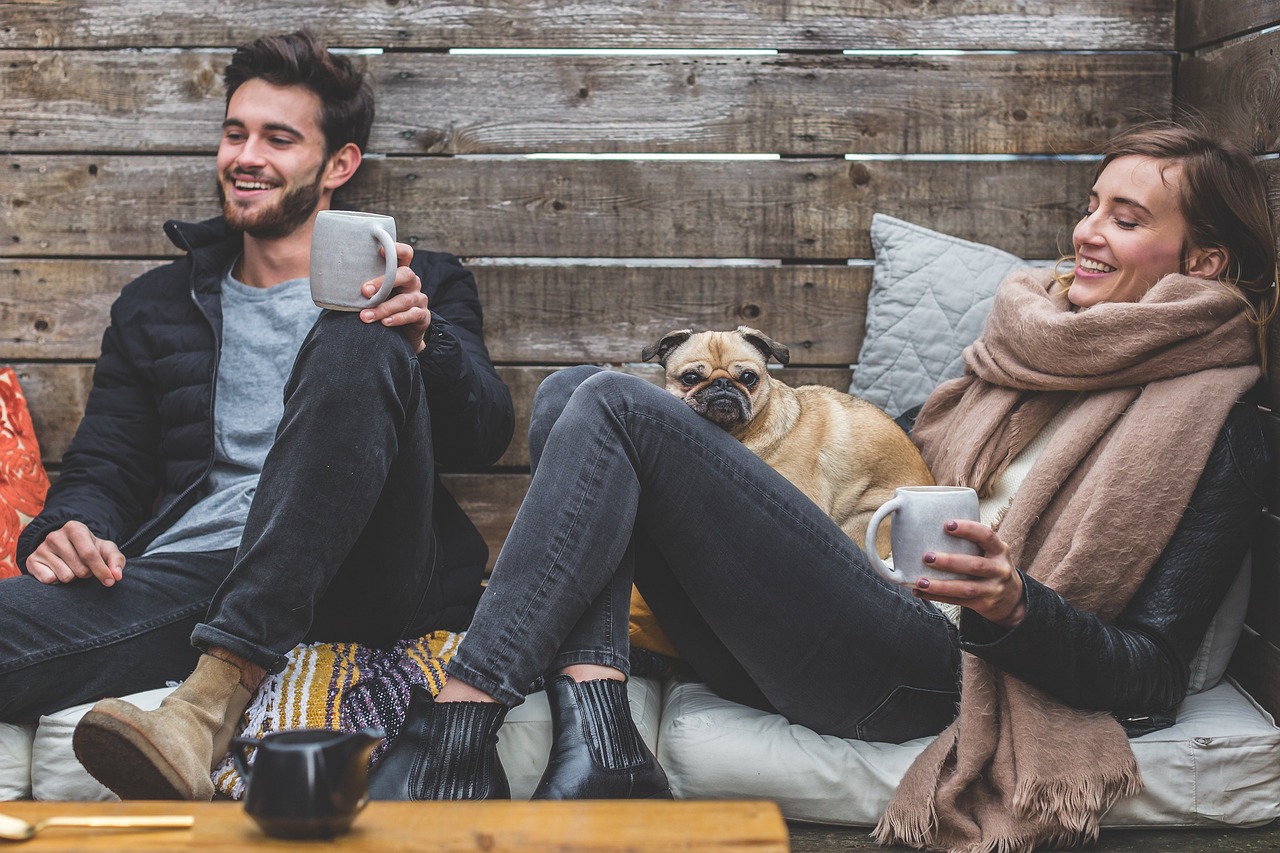 merry christmas, man, woman, dog, pet, pug, owners, couple, relationship, warm clothes, cozy, scarf, jackets, jeans, boots, fashion, people, happy, love, female, young, male, adult, caucasian, happiness, animal, romantic, portrait, smile, smiling, girlfriend, date, boyfriend, together, person, lovers, sitting, relaxing, rustic, cushions, couch, laughing, enjoying, coffee